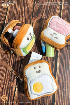 Three Toasty plush zip pouches, including an open pouch holding toiletries.